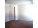 This bedroom features neutral carpet, white walls, and a standard door at 27 Perch Dr, Kissimmee, FL 34759