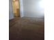 Bedroom with neutral carpet and a glimpse into the attached bathroom at 27 Perch Dr, Kissimmee, FL 34759