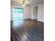 Bright living room featuring wood-look flooring, ceiling fan, and sliding glass doors to the backyard at 27 Perch Dr, Kissimmee, FL 34759