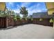 Spacious backyard patio with a wooden fence adorned with hanging plants at 2934 Tangerine Ct, Leesburg, FL 34748
