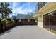 Wide backyard patio features a privacy fence with plants, a sliding door to the home, and palm tree views at 2934 Tangerine Ct, Leesburg, FL 34748