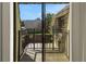 View from balcony showing garden, fence, and neighboring buildings at 2934 Tangerine Ct, Leesburg, FL 34748