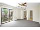 Bright bedroom with carpeted floors, closet, sliding glass doors to deck, and attached bathroom at 2934 Tangerine Ct, Leesburg, FL 34748