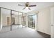 Bright bedroom with sliding door access to a balcony and mirrored closet at 2934 Tangerine Ct, Leesburg, FL 34748