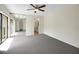 Spacious bedroom with balcony access, closet, and an ensuite bathroom at 2934 Tangerine Ct, Leesburg, FL 34748