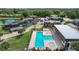 A bird's-eye view shows a shared pool and spa with palm trees and multiple buildings nearby at 2934 Tangerine Ct, Leesburg, FL 34748
