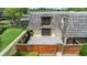 Charming townhouse featuring a private patio with wood fence, lush landscaping, and second story balconies at 2934 Tangerine Ct, Leesburg, FL 34748