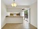 A kitchen featuring a breakfast bar, tiled floors, modern lighting, and sliding doors that seamlessly blend indoor/outdoor living at 2934 Tangerine Ct, Leesburg, FL 34748