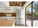 Bright kitchen features white cabinets, modern stainless steel appliances, and a sliding door to the outdoors at 2934 Tangerine Ct, Leesburg, FL 34748