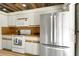 Bright kitchen features white cabinets, modern stainless steel appliances, and attractive wood-style counters and ceiling at 2934 Tangerine Ct, Leesburg, FL 34748