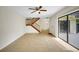 Spacious living room with tiled floors, stairs, and sliding glass doors enhances an airy atmosphere at 2934 Tangerine Ct, Leesburg, FL 34748