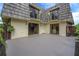 An expansive patio with access to the home's sliding doors and balconies above, providing ample outdoor living space at 2934 Tangerine Ct, Leesburg, FL 34748