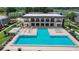 Aerial view of a large community pool, lounge chairs, and meticulously kept grounds for leisure at 2934 Tangerine Ct, Leesburg, FL 34748