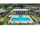 Aerial view of the community pool and clubhouse featuring a large in-ground pool and hot tub at 2934 Tangerine Ct, Leesburg, FL 34748