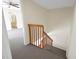 Carpeted stairwell with wooden railing at 2934 Tangerine Ct, Leesburg, FL 34748