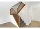 Carpeted stairwell with wooden railing and tiled floor at 2934 Tangerine Ct, Leesburg, FL 34748
