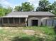 Backyard with a screened porch and two sheds for outdoor storage at 30641 County Road 435, Sorrento, FL 32776