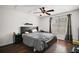 Bedroom features a ceiling fan, dark wood floors, and a large window at 30641 County Road 435, Sorrento, FL 32776