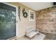 Inviting front porch with white bench, wreath, exterior lighting, and house number display at 30641 County Road 435, Sorrento, FL 32776