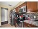Efficient kitchen with modern appliances, sleek countertops, and dark cabinetry at 30641 County Road 435, Sorrento, FL 32776