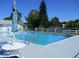 Community pool with lounge chairs and umbrellas at 3209 Manatee Rd, Tavares, FL 32778