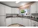 Bright and airy kitchen with white cabinetry, modern appliances, and a window with natural light at 3209 Manatee Rd, Tavares, FL 32778