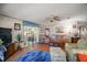 Cozy living room with hardwood floors, ceiling fan, comfortable seating, and plenty of natural light at 3209 Manatee Rd, Tavares, FL 32778
