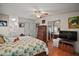 Comfortable main bedroom with a decorative wooden bed frame, closet, and ensuite bathroom access at 3209 Manatee Rd, Tavares, FL 32778