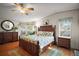 Serene main bedroom features a decorative wooden bed frame and plenty of natural light at 3209 Manatee Rd, Tavares, FL 32778
