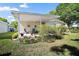 Private patio overlooking landscaped yard and lush greenery at 3209 Manatee Rd, Tavares, FL 32778
