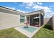 View of screened-in lanai and yard, showing backyard space and home's exterior at 3222 Miller Stachler St, The Villages, FL 32163