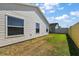 Exterior view of the house with a well-maintained lawn and a fenced backyard at 3222 Miller Stachler St, The Villages, FL 32163