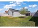 Exterior view of home, showcasing the fenced-in yard and screened-in patio at 3222 Miller Stachler St, The Villages, FL 32163