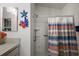Bright bathroom features vanity, mirror, and shower with decorative fish and starfish wall art at 3222 Miller Stachler St, The Villages, FL 32163