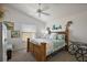 Cozy bedroom features a decorative ceiling fan, window, wooden bed, and seaside-themed decor at 3222 Miller Stachler St, The Villages, FL 32163