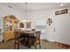 Dining area with a wood table and seating; natural light and a display cabinet enhance the space at 3222 Miller Stachler St, The Villages, FL 32163