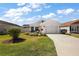 Charming home with a manicured lawn, a two-car garage, and lovely landscaping at 3222 Miller Stachler St, The Villages, FL 32163