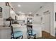 Bright kitchen features white cabinetry, stainless steel appliances, and a convenient breakfast bar with modern stools at 3222 Miller Stachler St, The Villages, FL 32163