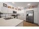 Modern kitchen with stainless steel appliances, white cabinets, and stylish decor above the cabinets at 3222 Miller Stachler St, The Villages, FL 32163