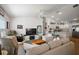 Bright living room featuring white walls, vaulted ceilings, and an open floor plan with a view into the kitchen at 3222 Miller Stachler St, The Villages, FL 32163