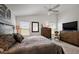 Comfortable main bedroom with soft lighting, large windows, and ample closet and dresser storage at 3222 Miller Stachler St, The Villages, FL 32163