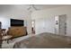 Main bedroom featuring high ceilings, large windows, and a view into the en suite bathroom at 3222 Miller Stachler St, The Villages, FL 32163