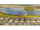 Aerial view of homes located near a lake with a marker indicating the location of the property at 3256 Canna Lily Pl, Clermont, FL 34711
