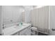 Bathroom featuring a modern vanity, toilet, shower with curtain and a neutral color palette at 3256 Canna Lily Pl, Clermont, FL 34711