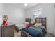 bedroom has two beds, neutral walls, and a window providing natural light at 3256 Canna Lily Pl, Clermont, FL 34711
