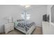 This bedroom features bright natural light, a comfortable bed, and a white-themed design at 3256 Canna Lily Pl, Clermont, FL 34711