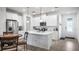 Bright kitchen featuring white cabinets, a central island, stainless steel appliances, and modern fixtures at 3256 Canna Lily Pl, Clermont, FL 34711