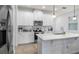 Modern white kitchen with stainless steel appliances and quartz countertops at 3256 Canna Lily Pl, Clermont, FL 34711