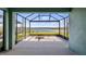 A screened lanai overlooking a beautiful lake, offering a serene and picturesque view at 3256 Canna Lily Pl, Clermont, FL 34711