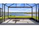 Spacious screened-in lanai offers stunning views of the serene lake and lush surroundings at 3256 Canna Lily Pl, Clermont, FL 34711